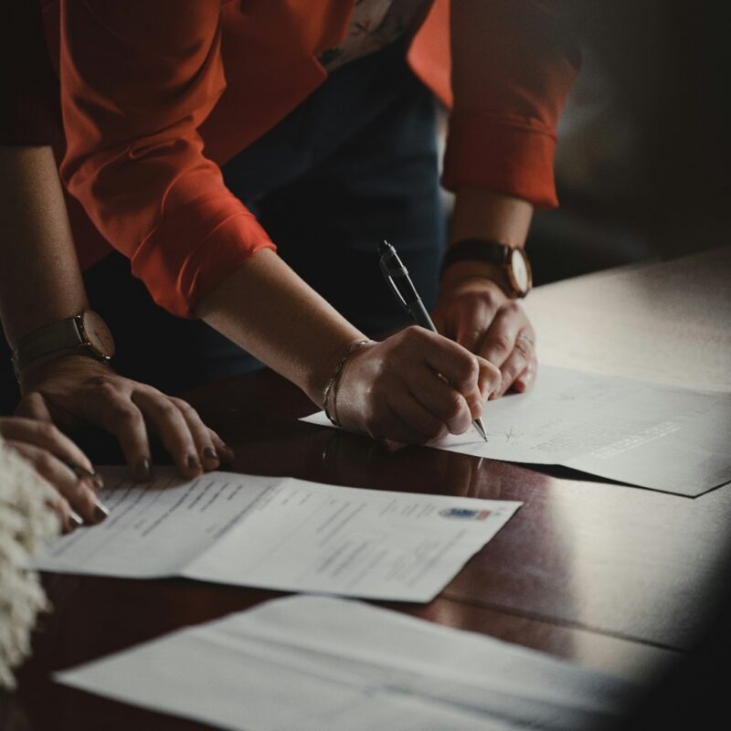 Young adult viewing and signing waste collection permit records